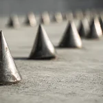 metal_spikes_lining_a_concrete_surface (1)